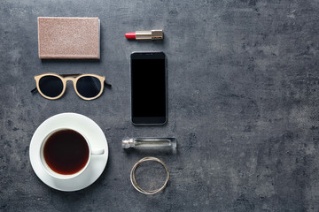 Obraz na płótnie Canvas Flat lay composition with cup of coffee, smartphone and stylish accessories on grey background. Blogger concept
