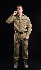 Male security guard using portable radio transmitter on dark background