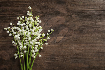 Fresh spring flowers on wooden background, top view