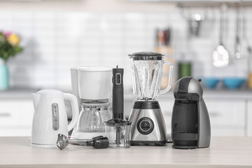 Different modern kitchen appliances on table indoors. Interior element