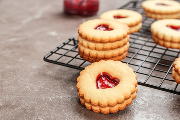Traditional Christmas Linzer cookies with sweet jam on cooling rack