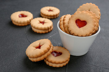 Traditional Christmas Linzer cookies with sweet jam on table