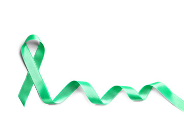 Obraz na płótnie Canvas Green ribbon on white background, top view. Cancer awareness