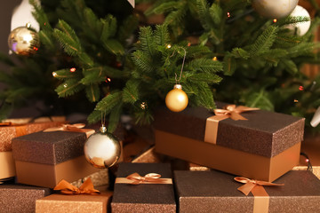 Fototapeta na wymiar Beautiful Christmas tree with decor and gift boxes, closeup