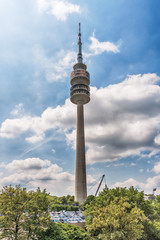 Naklejka premium Munich, Germany - June 09, 2018: A low angle view of the Olympic Tower (Olympiaturm) in the Olympic Park in Munich, Germany.