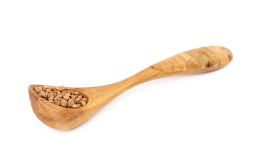 Spoon of buckwheat seeds isolated