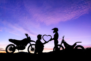 silhouette of romantic lovers and motocross with sunset