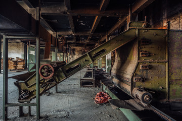 Abandoned tea factory with remnant of rusty equipment 