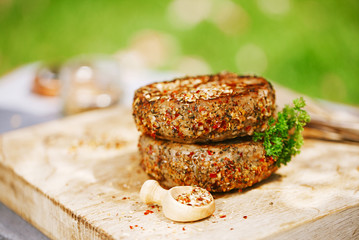 lamb burgers spiced by mint and lamb rub on wood board