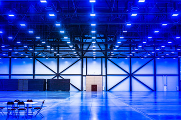 Empty warehouse. Many lamps on the ceiling. Empty space.