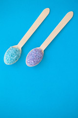 Spa. Organic Sea Salt in Two Wooden Spoons On a Blue Background With a Space For a Text.