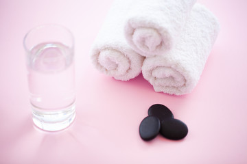 Obraz na płótnie Canvas Spa. Rolled White Body Towels on Pink Background. Towel Concept. Photo For Hotels and Massage Parlors. Purity and Softness. Towel Textile.