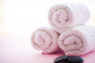 Obraz na płótnie Canvas Spa. White Cotton Towels Use In Spa Bathroom on Pink Background. Towel Concept. Photo For Hotels and Massage Parlors. Purity and Softness. Towel Textile.