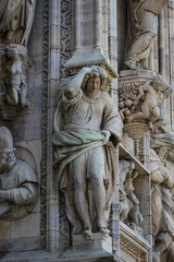 Obraz premium Sculptures of saints and martyrs decorating the Cathedral of Milan (Duomo di Milano) are shot close-up. 