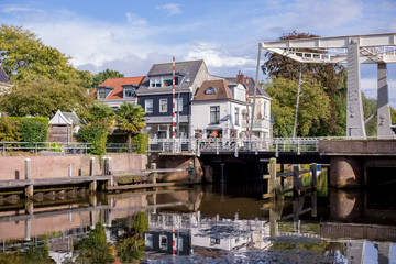Fototapeta na wymiar Canal view in a Dutch city with a draw bridge