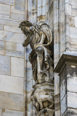 Obraz premium Sculptures of saints and martyrs decorating the Cathedral of Milan (Duomo di Milano) are shot close-up. 