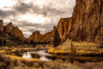 A river running through a valley with large rock formations on either side, Oregon