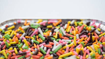 cake chocolate with rainbow close up on white background