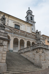 Fototapeta na wymiar Clusone (Lombardia, Italia) - Scorcio della scalinata d'ingresso e campanile della Basilica di Santa Maria Assunta costruita dal 1688 al 1698