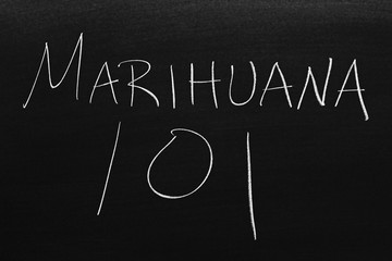 The words Marihuana 101 on a blackboard in chalk.  Translation: Marijuana 101