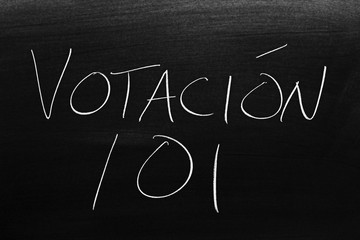 Fototapeta na wymiar The words Votación 101 on a blackboard in chalk. Translation: Voting 101