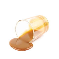 Glass shot of caramel sauce isolated