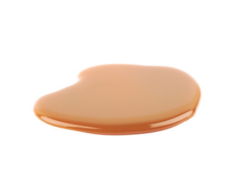 Splash of caramel sauce isolated