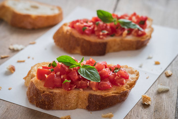 Bruschetta bread with chopped tomato and basil