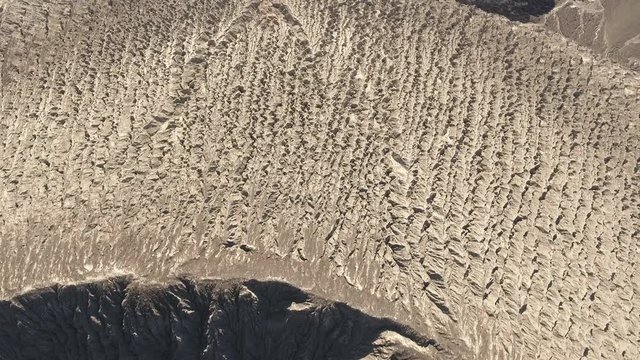Flight over of volcano crater rim and cooled lava flow - San Benedicto, Mexico