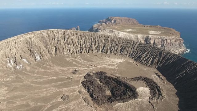 Flyover of volcano crater in a volcanic island - San Benedicto, Mexico