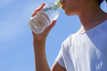 A woman or a girl who drinks water. Image of hydration, health, beauty, sports etc.  ...