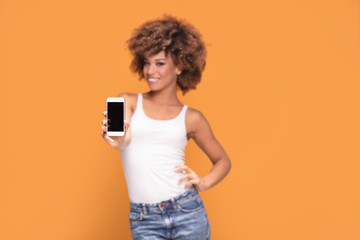 Smiling afro girl showing blank screen mobile phone.