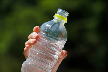 One person drinking water of a plastic bottle.  ペットボトルの水を飲む人