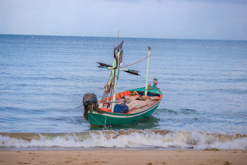 Fototapeta premium Fishing boats landing at the coast. During the strong sea breeze.