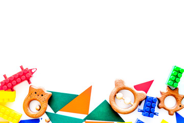 Fototapeta premium Educational toys for children mockup. Plastic blocks and clacks on white background top view copy space