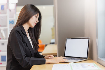Business woman working with computer laptop in modern office background.