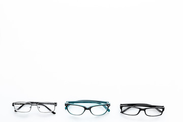 Glasses concept. Set of glasses with different eyeglass frame and transparent lenses on white background top view copy space pattern