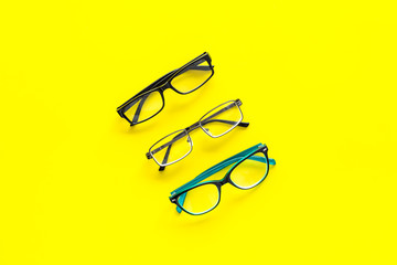Glasses concept. Set of glasses with different eyeglass frame and transparent lenses on yellow...