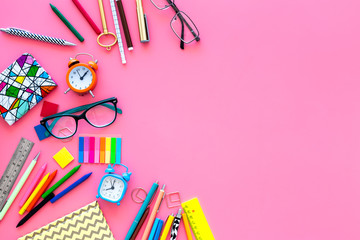 School supplies. Student stationery mockup with glasses and notebook  on pink background top view space for text