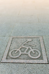 Granite bicycle sign on walk way