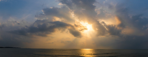 Sunset with dramatic cloud over sea