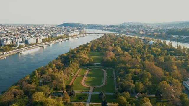 Aerial View of Margaret Island in Budapest with Beautiful Park in the middle , Tilting down camera movement Sunset