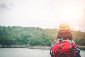 Female tourists in beautiful nature in tranquil scene, concept tourists backpack.