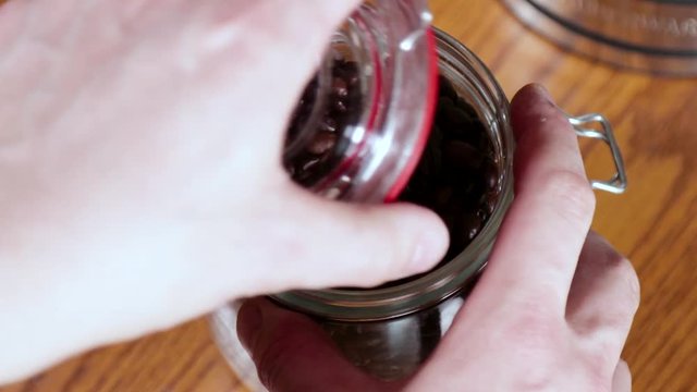 Opening a mason jar filled with fresh coffee beans. NOTE: This was recorded in 60 fps.