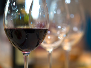 White wine pouring into glasses, close up view.