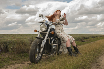 red-haired girl in a white dress and boots along with a motorcycle. lavender field