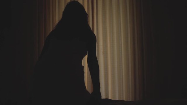 Beautiful girl waking up from the bed is wearing white towel opens curtains and go to sea view terrace. Young woman looking at blue sky, ocean landscape horizon in vacation. slow motion. 3840x2160