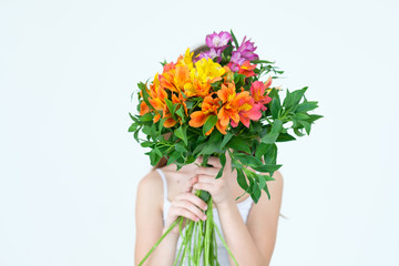 little girl with a flower bouquet gift. tender floral alstroemeria arrangement for mothers or womens day.