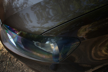 The hood of the car, the left wing of the car and the headlamp
