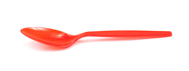 Red plastic spoon isolated on white background